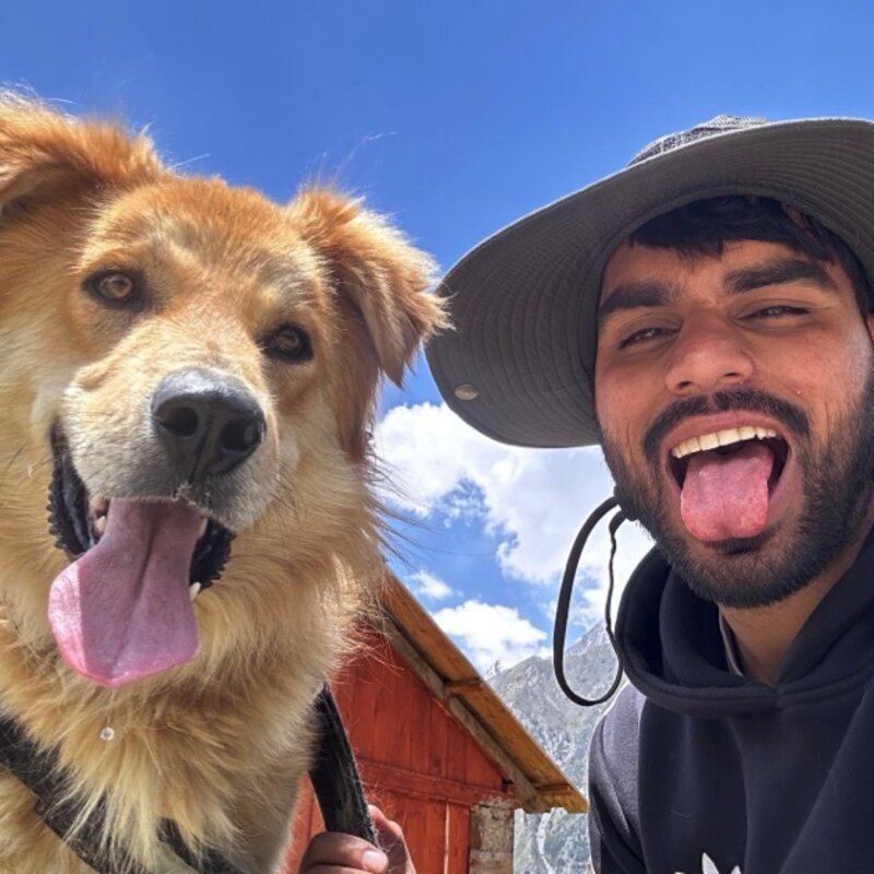 Akshay Thakur with a mountain dog in Himachal Pradesh