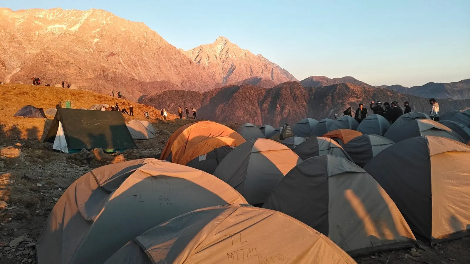 Tents on the Triund ridge at sunrise with the Dhauladhar behind