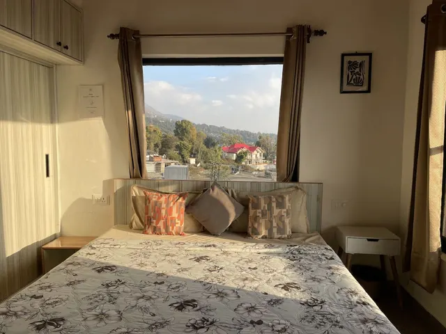 Bedroom with a valley view through the window