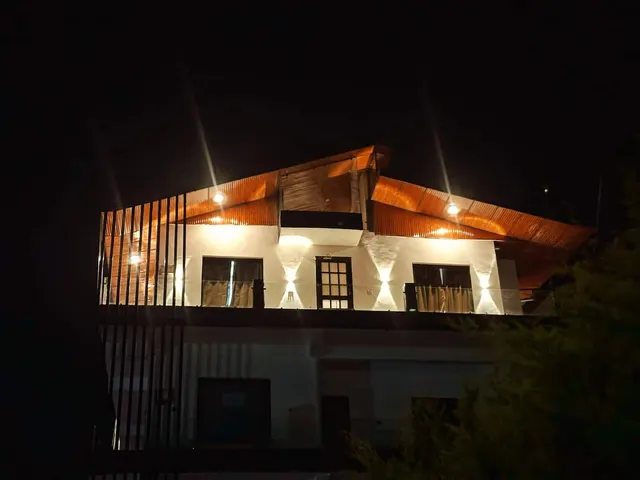 Ghonslaa Home lit up at night, top floor with balcony