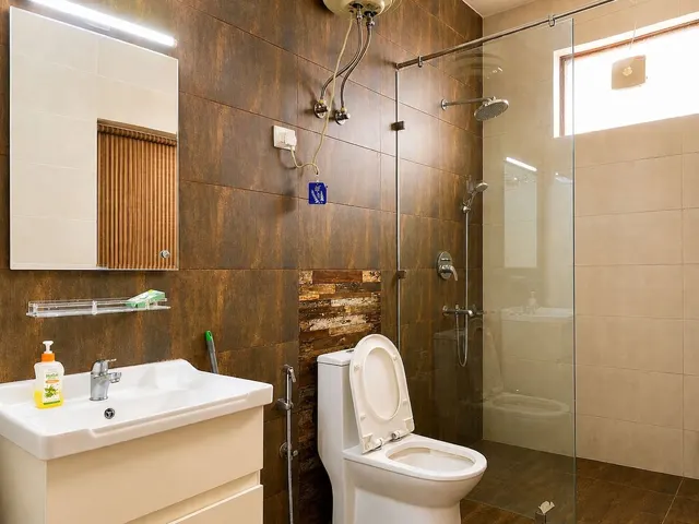 Attached bathroom with geyser and glass shower