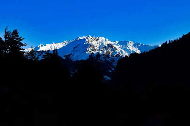 Snowcapped peaks under blue sky, Manali